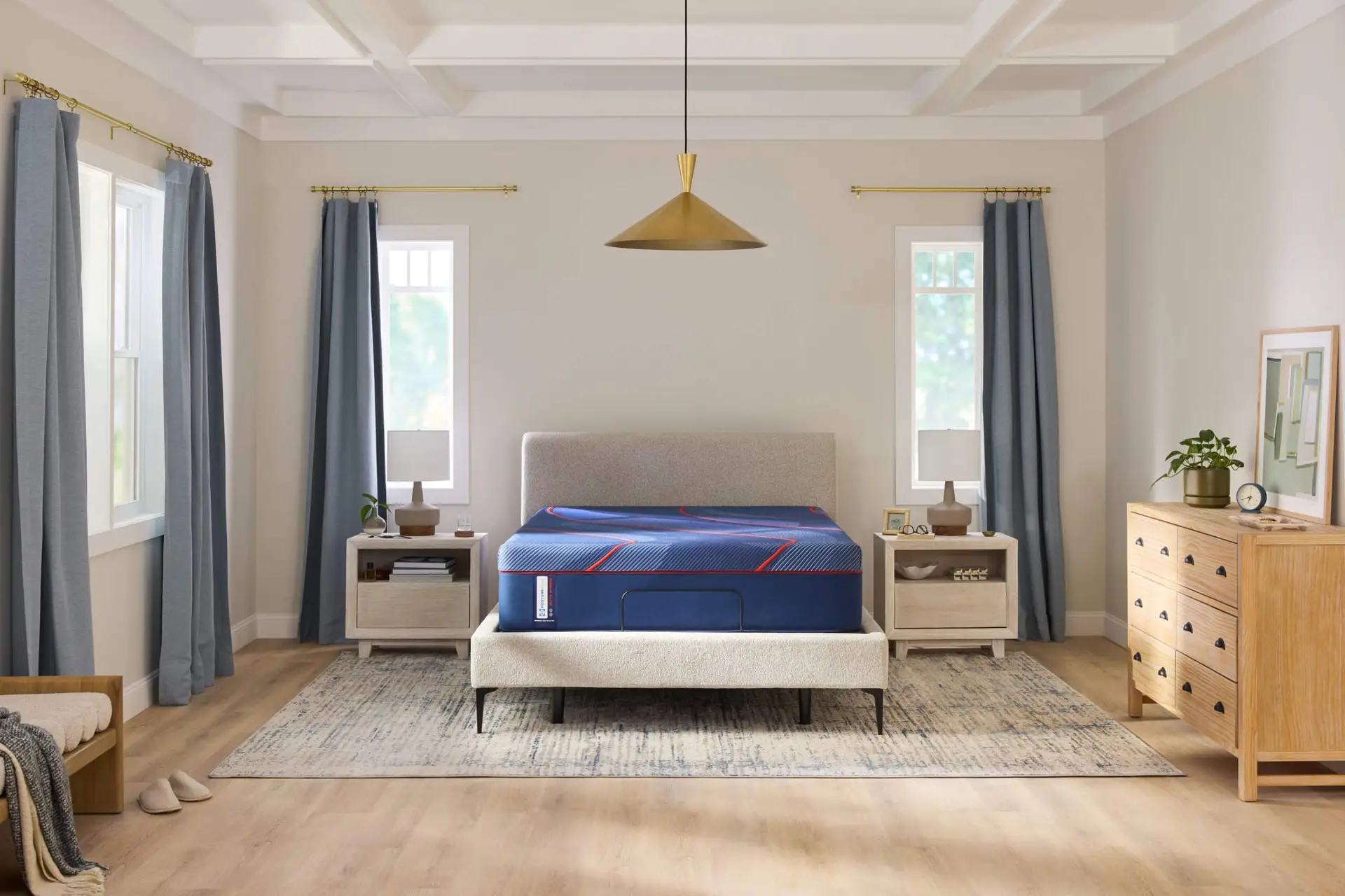 Sealy High Point II Hybrid mattress on a stylish bed frame in a modern bedroom setting with natural light, blue curtains, and wooden furniture, highlighting comfort and support features.
