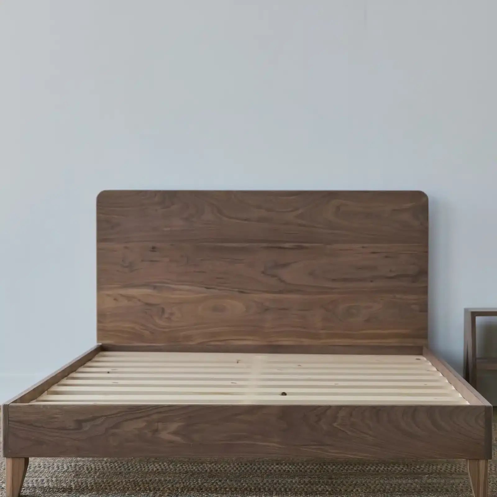 Avocado City Bed Frame With Headboard-Walnut 1 Avocado City Bed Frame with Headboard in Walnut, showcasing eco-friendly design and craftsmanship, highlighting natural wood finish and slatted base for mattress support.
