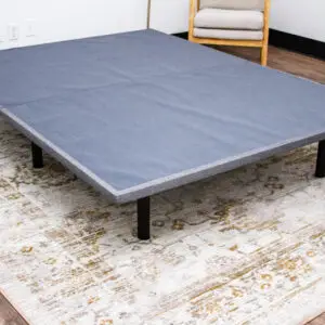 Gray BedTech X-Plat foundation on a decorative rug, designed for optimal mattress support, featured on Healthy ZZZ's Sit & Sleep product page.