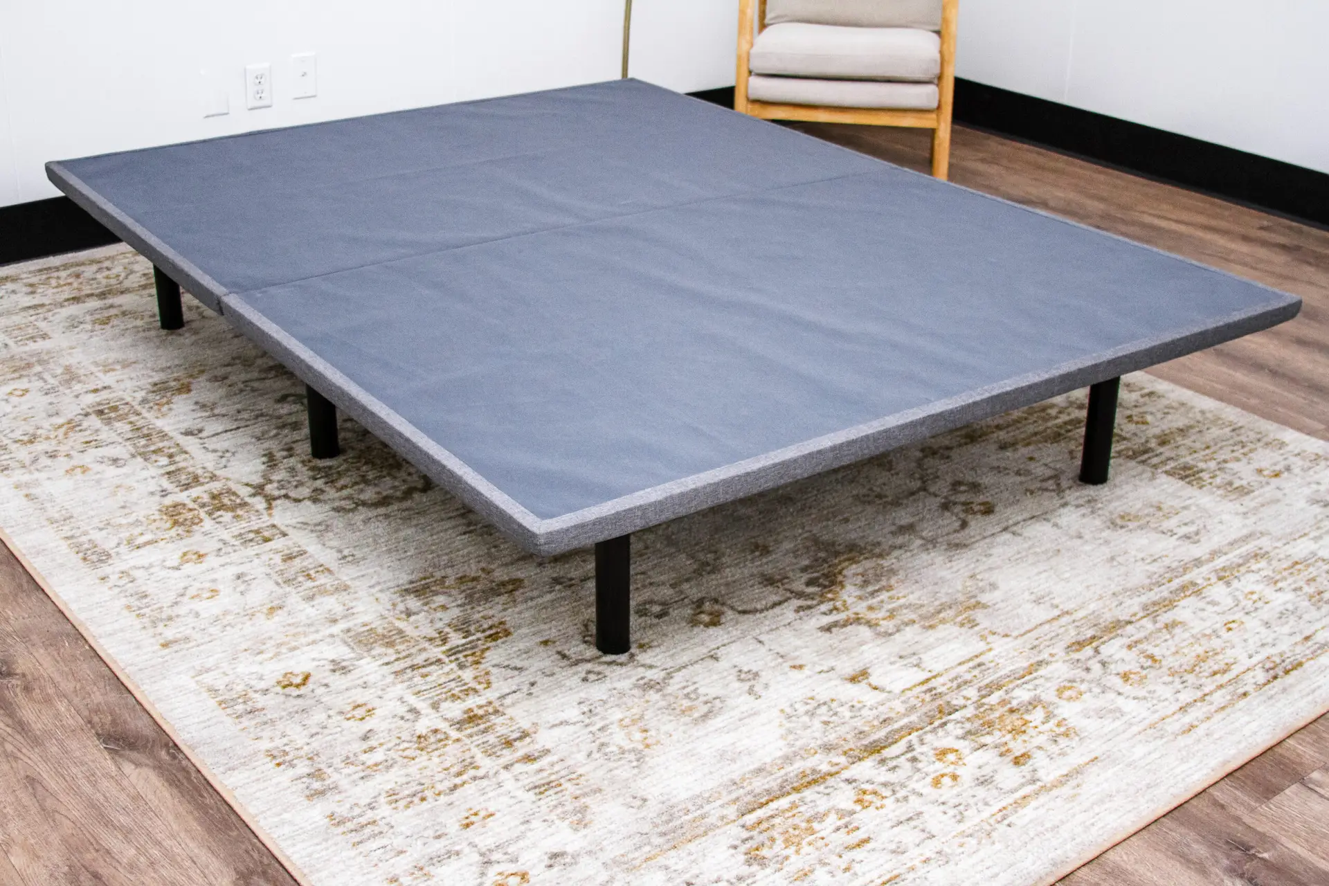 Bedtech X-Plat 1 BedTech X-Plat platform foundation in gray, designed for Tempur-Pedic mattresses, showcasing a sturdy construction and modern aesthetic on a decorative rug.