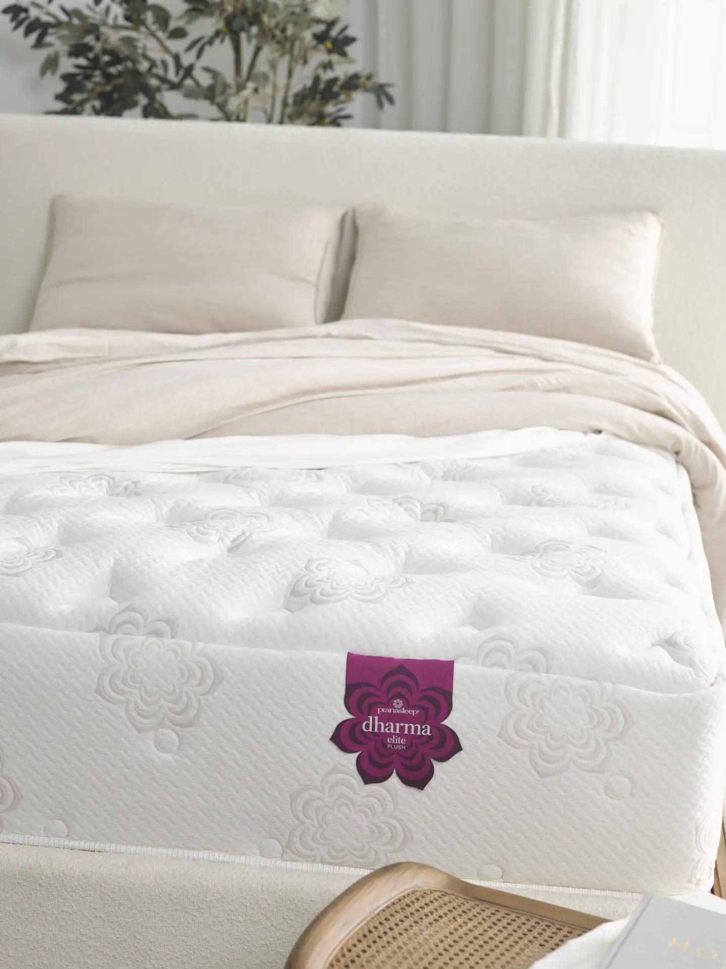 Pranasleep Dharma Elite Hybrid 5 PranaSleep Dharma Elite Hybrid mattress on a bed with plush bedding, showcasing its premium Talalay latex design and cooling features.