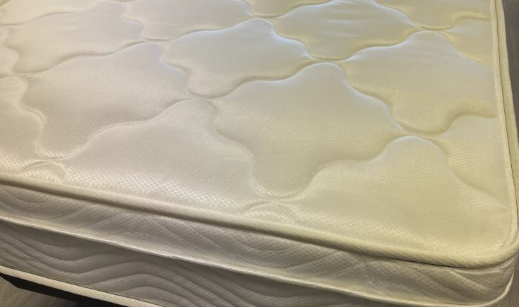 Close-up of a Silver Beach mattress featuring a modest pillow top design, emphasizing comfort and functionality for budget-friendly sleeping arrangements.