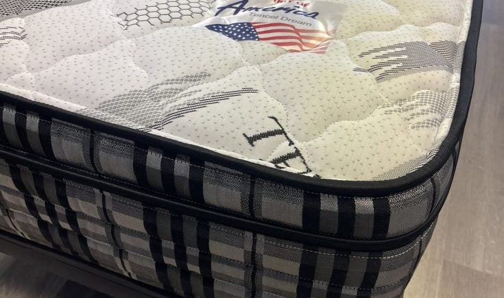 Tencel Dream mattress with a quilted surface, featuring a prominent "Made in America" label and a stylish black and white striped border, showcasing comfort and quality for budget-conscious shoppers.