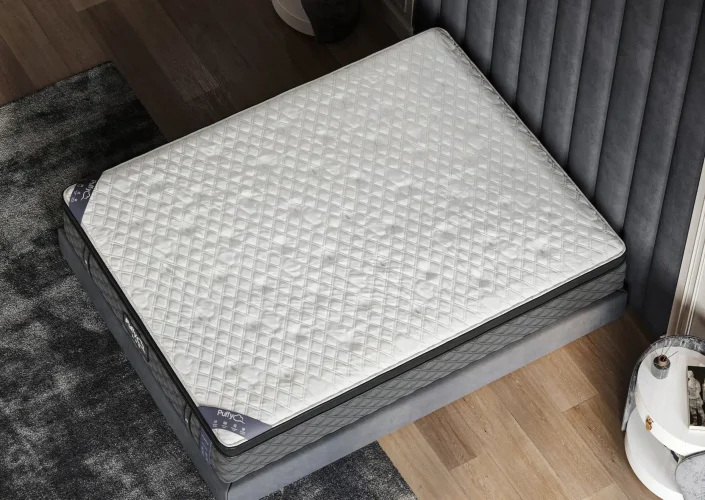 Puffy Lux Hybrid Mattress featuring a cool-to-the-touch quilted cover, placed on a stylish bed frame in a modern bedroom setting.
