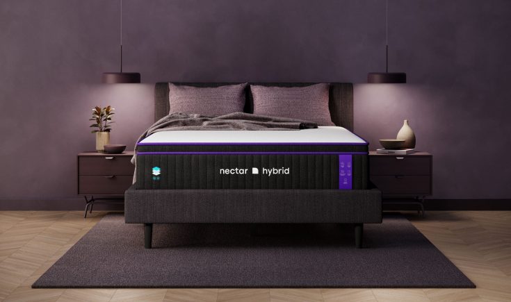 Nectar Hybrid mattress on a stylish bed frame with plush pillows and modern decor, emphasizing comfort and support for a restful night's sleep.