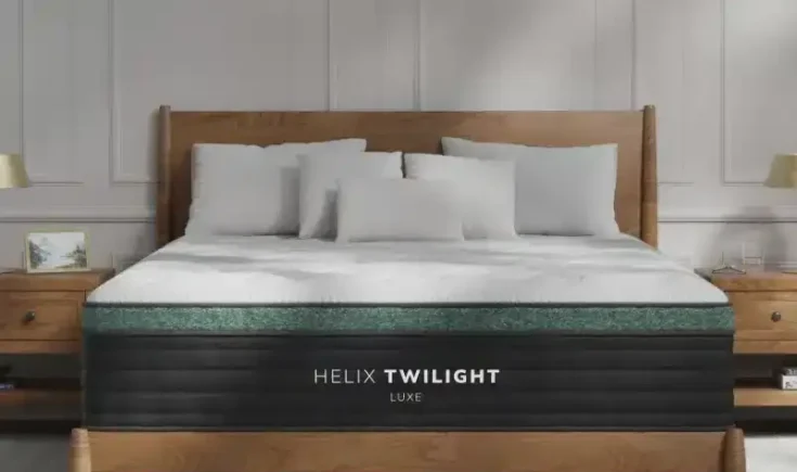 Helix Twilight Luxe hybrid mattress on a wooden bed frame, featuring plush pillows and a cooling top layer for enhanced comfort and support.
